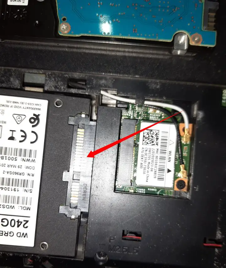 Place the new SSD in the slot to install it in laptop